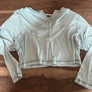 Light blue quarter-button long sleeved cropped top